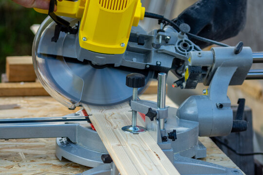 Sawing a board with a miter saw