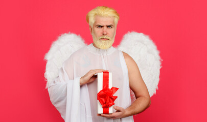 Valentines angel with gift box. Cupid with present. Serious bearded man with white wings. Valentine...