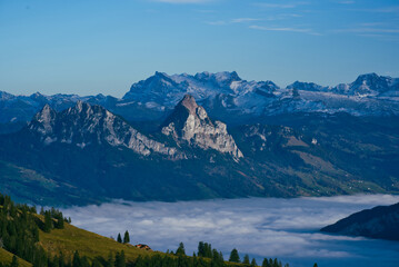 Obraz na płótnie Canvas Mythen peaks above sea of fog with Glärnisch peak in the background viewed from Rigi