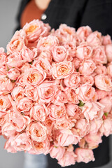 Peony-shaped roses. Beautiful mono bouquet of flowers in woman hand. Floral shop concept ....