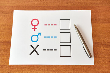 A person is determined by his gender. Sheet of paper with gender symbols. The right to one's identity.