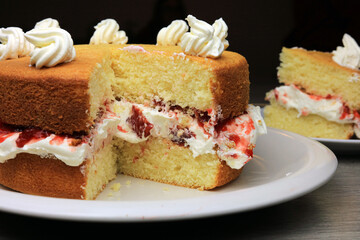 messy fresh cream and jam filling in a homemade sponge cake.