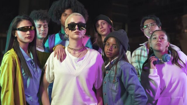 Group of modern teenager generation Z friends with funky style in the city at night