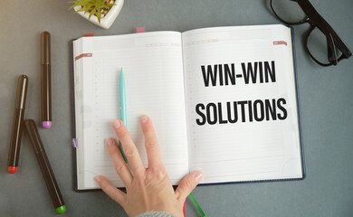 Text on notepad Win-Win solutions on gray tabl.