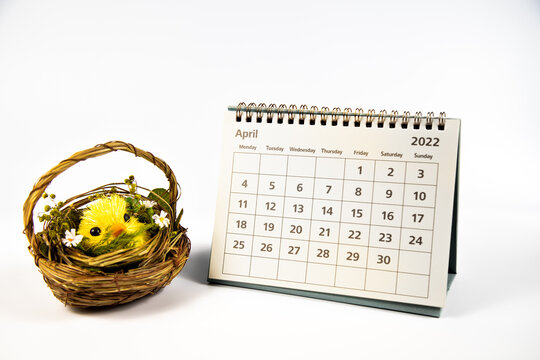 April 2022 calendar and yellow Easter chicken