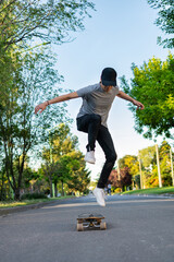 Young man practicing skating. On an asphalt street.