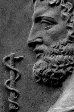 God of treatment Asclepius (Lat. Aesculapius). Fragment of an ancient statue.