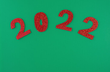happy new year 2022 background new year holiday card on green background bright red numbers.