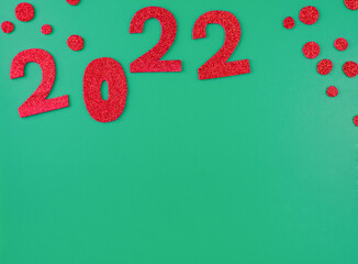 happy new year 2022 background new year holiday card on green background bright red numbers.