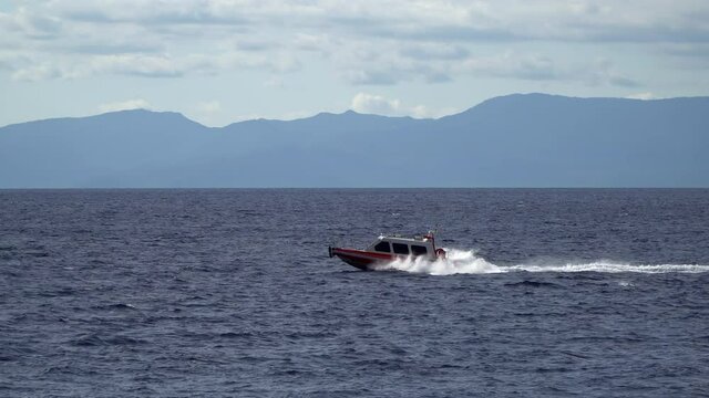 Small emergency yacht boat sailing fast at Mount Athos, Greece