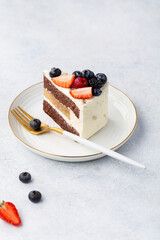 a piece of delicious chocolate cake with fresh berries, top view