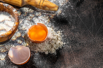 ingredients for dough on dark background