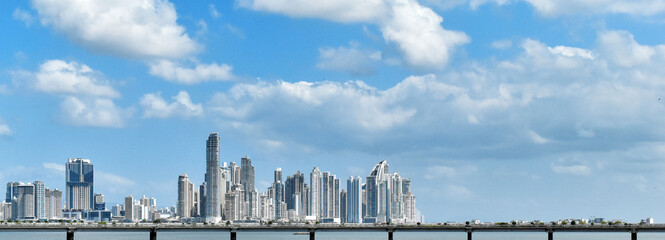 Panama City skyline, modern skyscraper buildings in downtown, in the foreground a bridge on poles