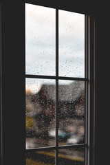 Dark window with rain water drops

