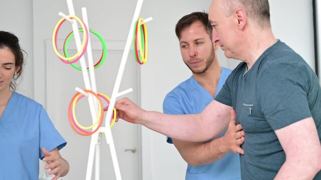 Group of patients with a disability exercising in rehabilitation hospital. High quality 4k footage