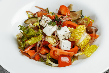Greek salad with fresh vegetables, feta cheese and black olives