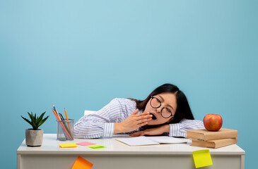 Deadline and overworking concept. Exhausted asian lady yawning and feeling tired, sitting at desk,...