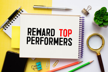 Reward top performers text memo written on a white background with pencils