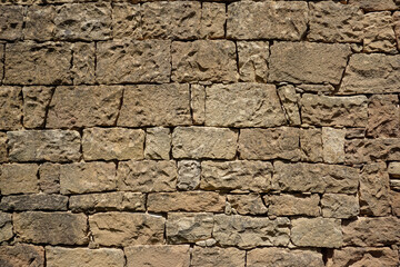 Texture of a yellow stone wall in Dagestan