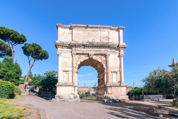Arch of Titus located in the Roman Forum in Rome during a sunny day. No people