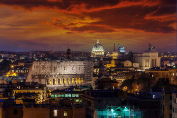 Fototapeta na wymiar Night view at Coliseum, Fatherland altar and St. Peter's cathedral in Rome with red sunset