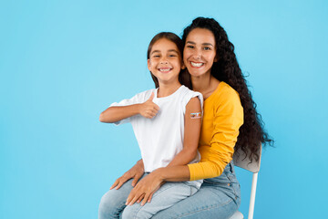 Girl And Mom Showing Arm And Thumbs-Up After Vaccination, Studio - obrazy, fototapety, plakaty
