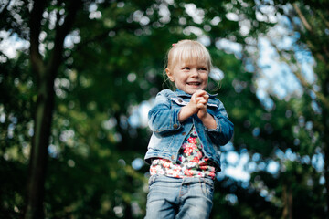 
little cute blonde girl on a walk in spring, portrait
