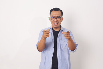 Lifestyle, travel and people concept. Portrait of enthusiastic handsome asian guy pointing fingers at camera and smiling, picking or recruiting to his team. Isolated on white background