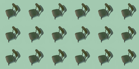 Minimalist concept: an empty wooden dining chair with a shadow on a green mint background. Art...