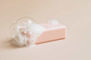 Natural organic handmade soap with large bubbles of foam on pastel background. Health beauty natural products concept. 