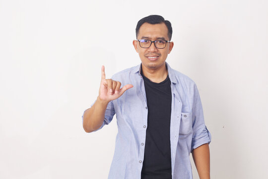 Asian man demonstrating the letter Y. sign language symbol for deaf human. Isolated on white background