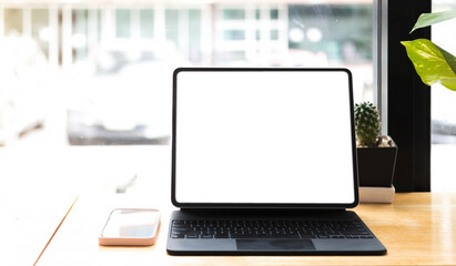 Blank screen Laptop computer and poster workspace background in modern office