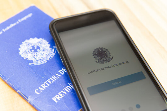 Florianopolis, Brazil. June 27, 2020: Close up of printed and digital work card (Carteira de Trabalho digital) on white background. Ministry of Labor and Employment (Minist&eacute;rio do Trabalho e Emprego).