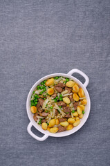 Baked gnocchi with stews and vegetables.