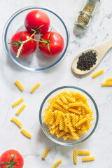 Fusilli pasta with tomato, black pepper and olive oil