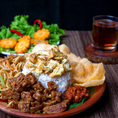 Nasi uduk or Uduk rice, traditional breakfast menu from Indonesia, served with prawn crackers