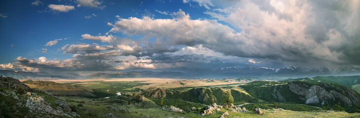 Fototapeta na wymiar Panoramic view of mountain valley, thundercloud, evening light