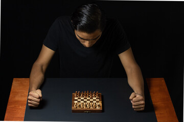chess player about to start the game, thinking about his strategy with closed fists