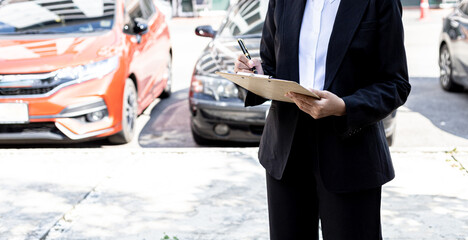 A person holding a file, a female employee of a car rental company is about to deliver the car to a customer who has signed a rental contract and paid the deposit. Car rental concept.