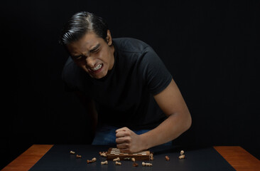 chess player angry and frustrated at having lost the game, pounding the chessboard with his fist