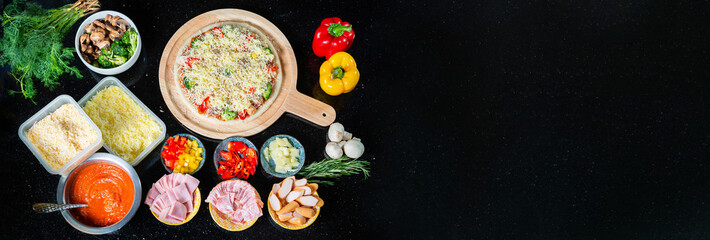 Food ingredients , Spices for cooking mushrooms, tomato sauce, cheese, sausage, bacon, bell pepper, ham, pineapple, parsley, broccoli and delicious pizza on black concrete background. View from above