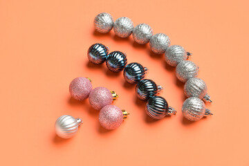 WiFi symbol made from Christmas balls on color background