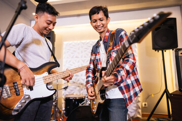 a bassist and guitarist enjoying playing musical instruments