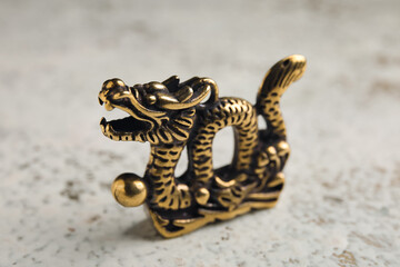 Figurine of Chinese dragon on light background