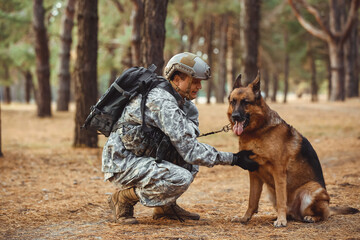 Soldier with military working dog outdoors