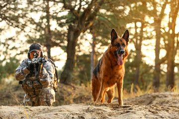 Soldier with military working dog during combat operation outdoors