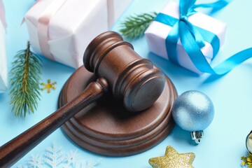 Judge's gavel, gifts and Christmas decor on color background