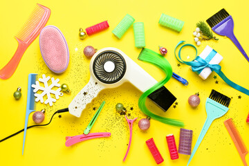 Hairdresser's tools and Christmas decor on color background
