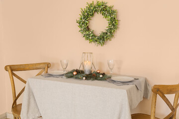 Table set for Christmas dinner on color background