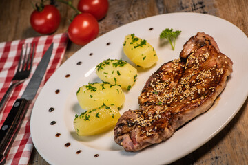 Recipe for grilled pork chop, maple syrup and fresh cilantro marinade, parsley, garlic, served with a salad.